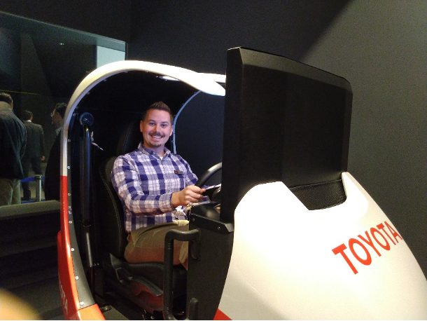 SDM student Brendan Horton sits in a simulation driving pod with the Toyota logo on the front