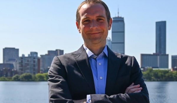 Portrait of Chad Holmes with the Boston skyline behind him