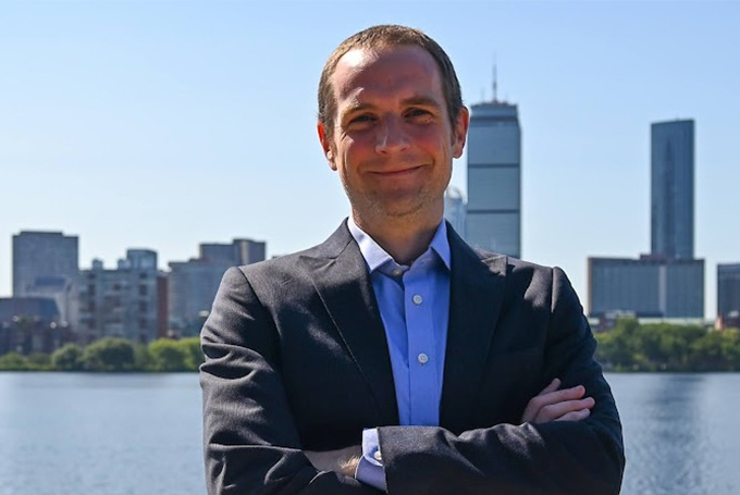 Portrait of Chad Holmes with the Boston skyline behind him