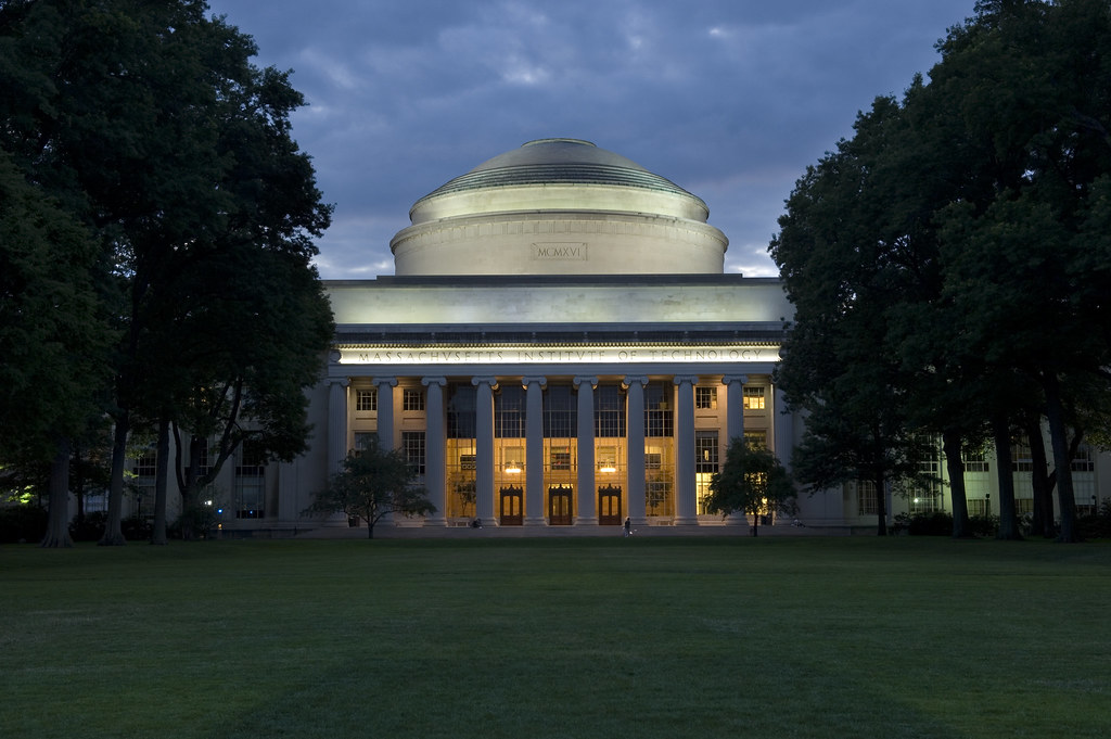 The MIT Dome seen at twilight against a dark blue sky.