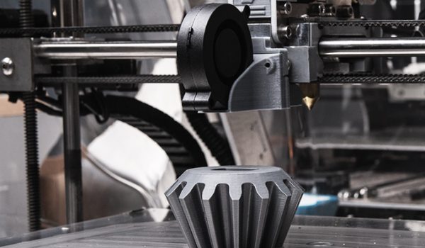 A 3d printer making a large gear-shaped object.