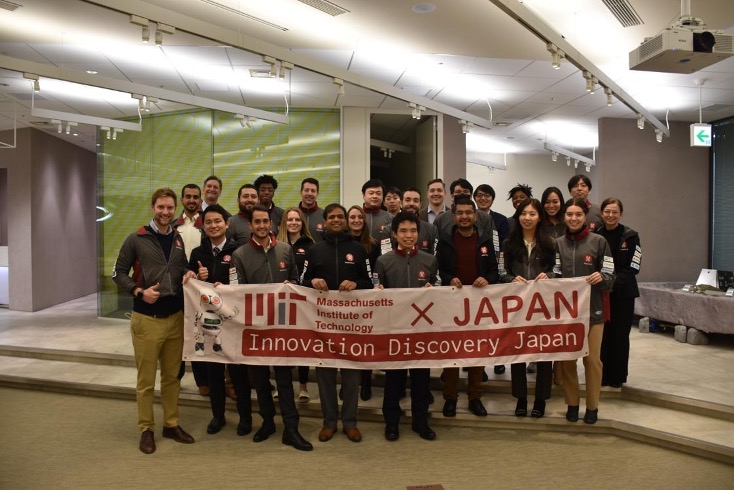 Students in the ispace office holding the MIT x Japan banner