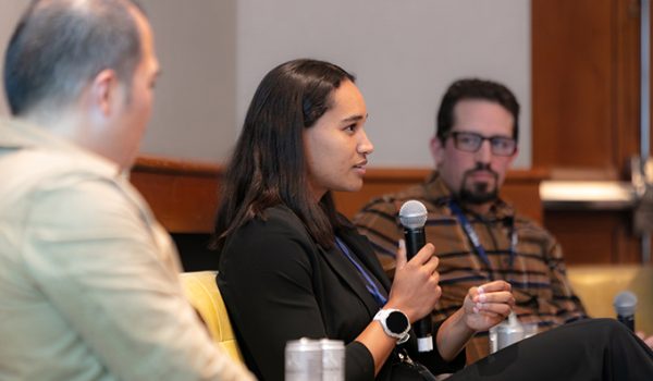 Noemie Midrez speaks while Tim Chiang and Jeremy Katz look on