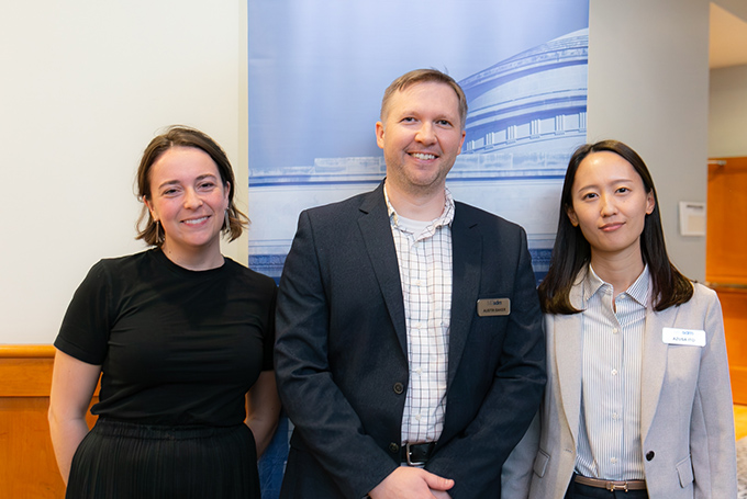 Molly Harwood, Austin Baker, and Azusa Ito, standing in front of a banner with MIT's Great Dome