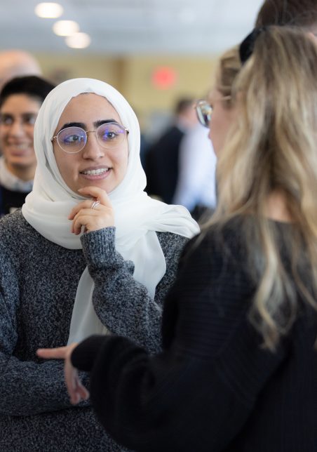 Students chatting in a busy hallway