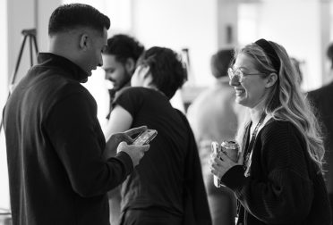 Two students talking to each other during a poster session