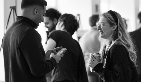 Two students talking to each other during a poster session