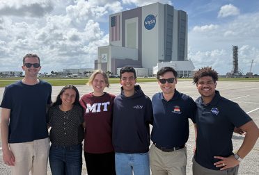 A group of students stand in front of NASA's Kennedy Space Center