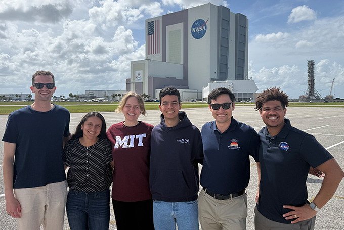 A group of students stand in front of NASA's Kennedy Space Center